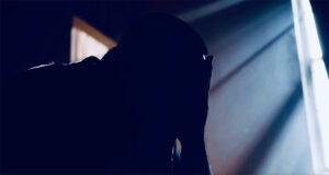 Silhouette of man with head in hands